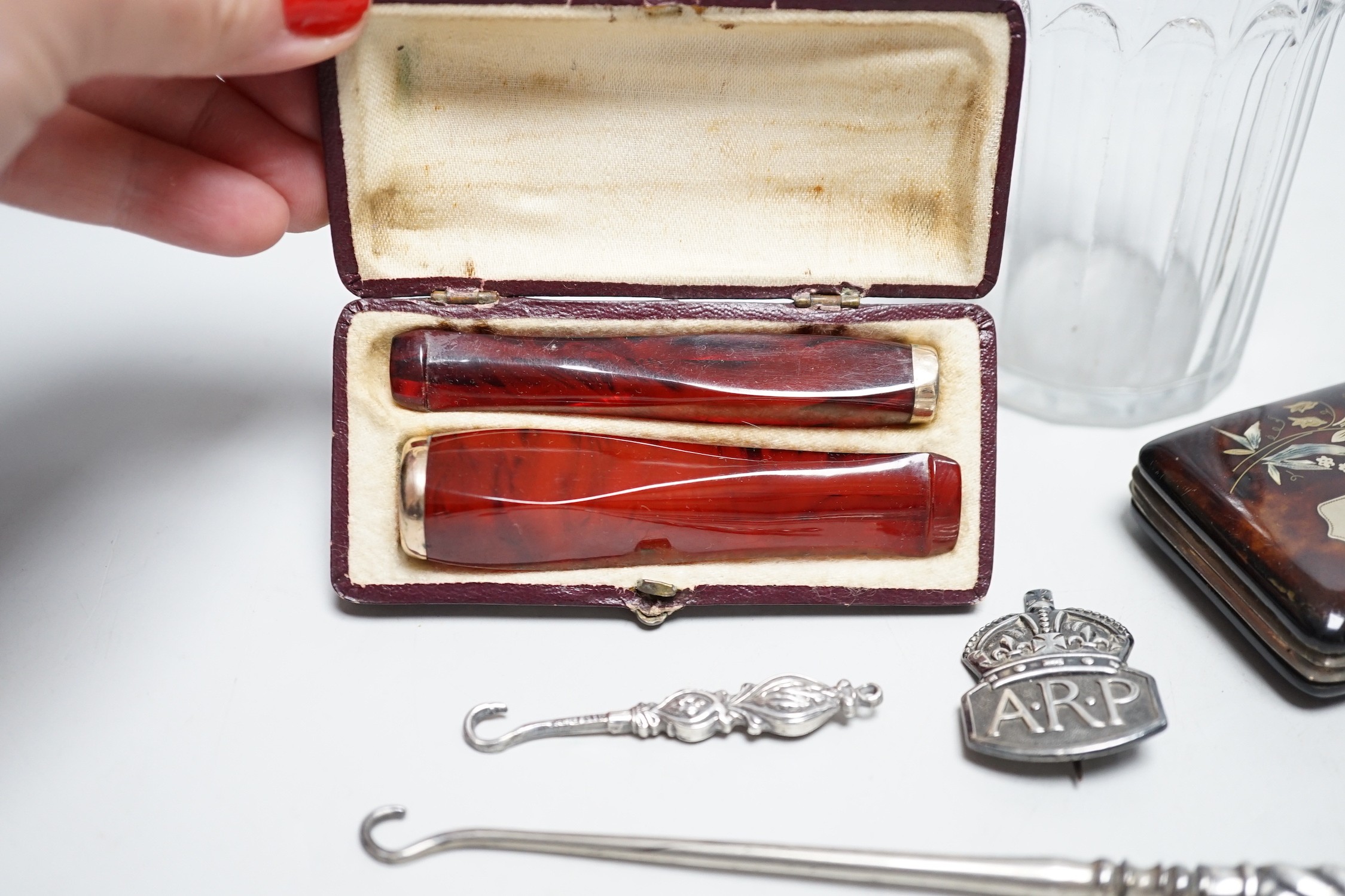 A Georgian silver mounted sugar sifter, a tortoiseshell and plique case, four silver items and two cased cheroot holders